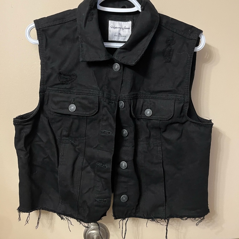 Distressed denim vest. Never worn. Good quality.